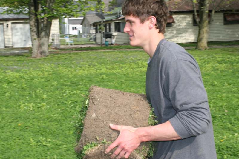 a man carrying a large piece of dirt