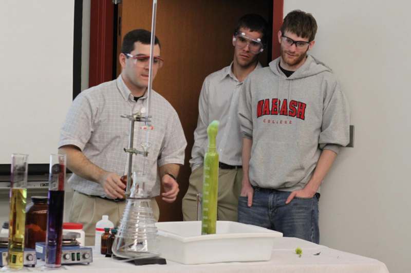 a group of men standing in front of a science lab