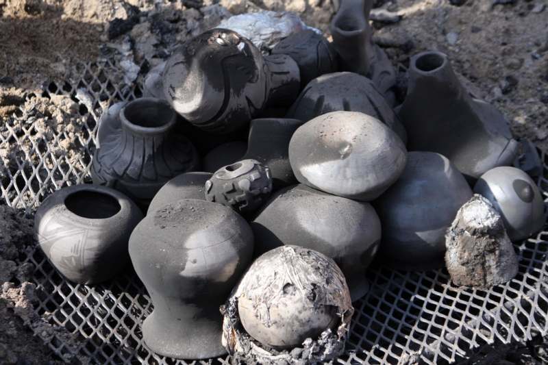 a pile of black pottery