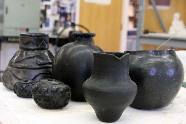 a group of black pottery
