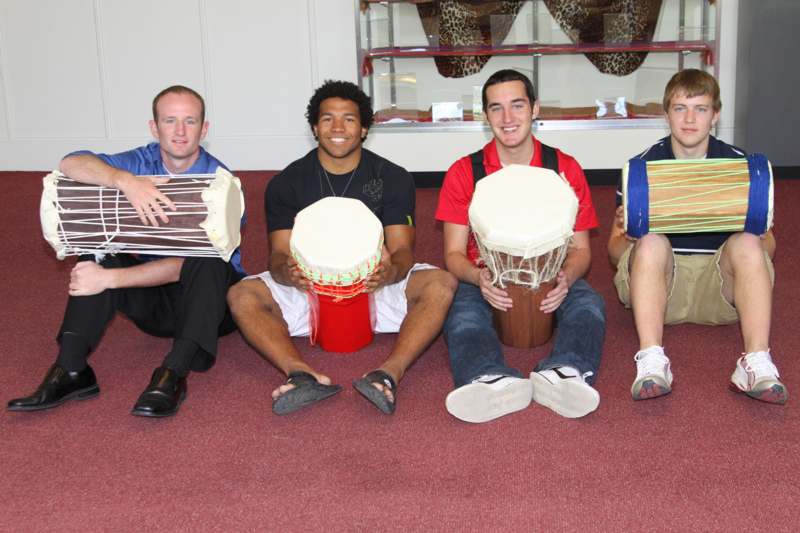 a group of men holding drums
