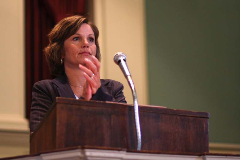 a woman speaking at a podium