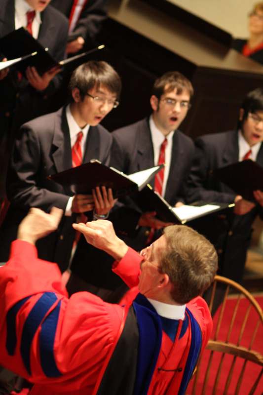 a group of men singing in a choir
