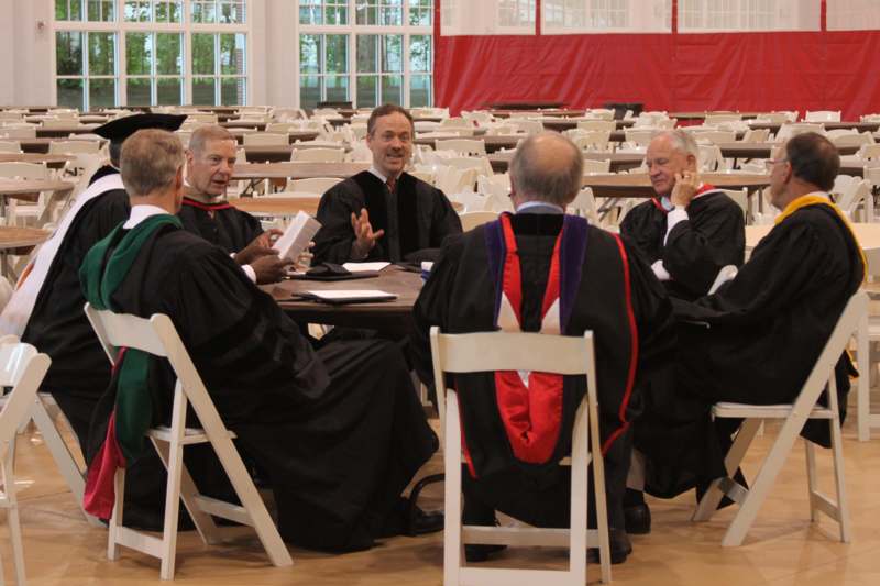 a group of men in robes sitting at a table