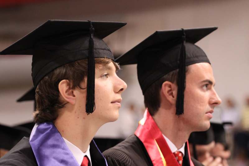 a group of men in graduation gowns