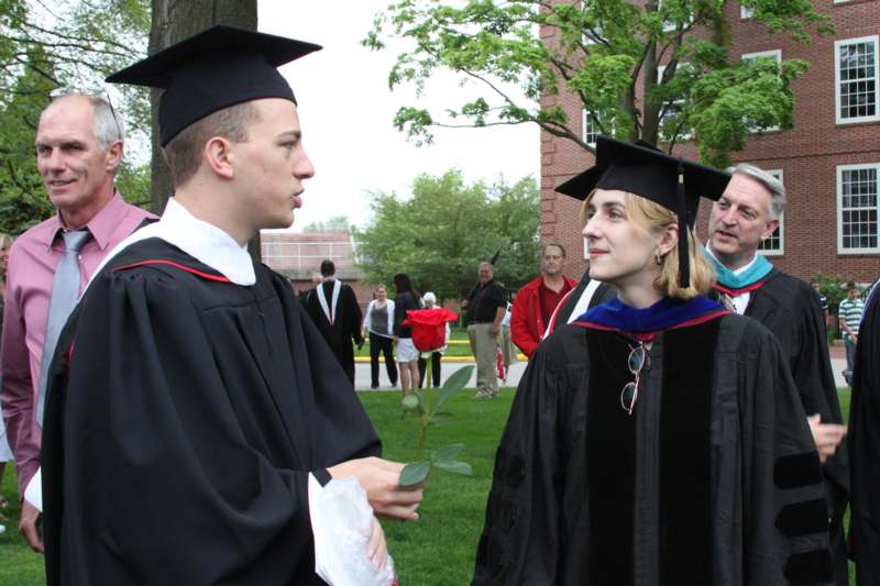 a man and woman in graduation gowns and cap and gowns