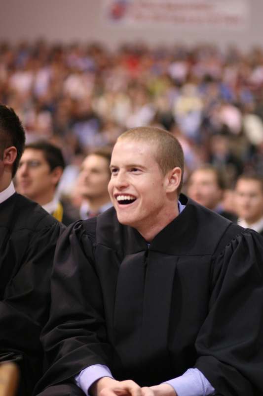 a man in a black robe laughing