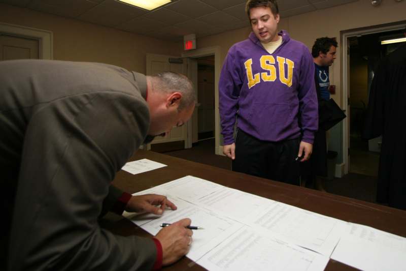 a man signing a document
