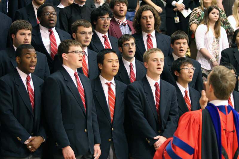 a group of people in suits singing