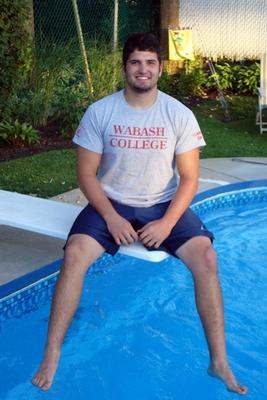 a man sitting on a pool