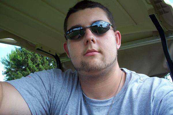 a man wearing sunglasses and looking at the camera