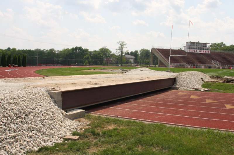 a track and field with a large metal beam