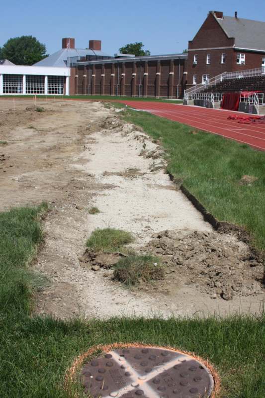 a dirt path next to a track