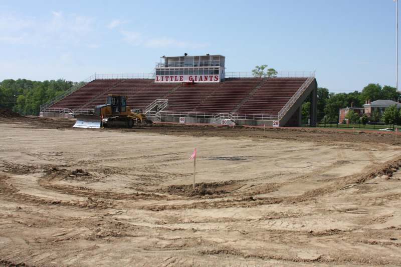 a bulldozer in front of a stadium