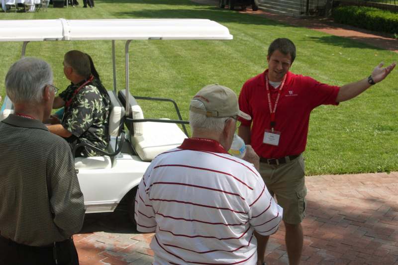 a man pointing at a golf cart