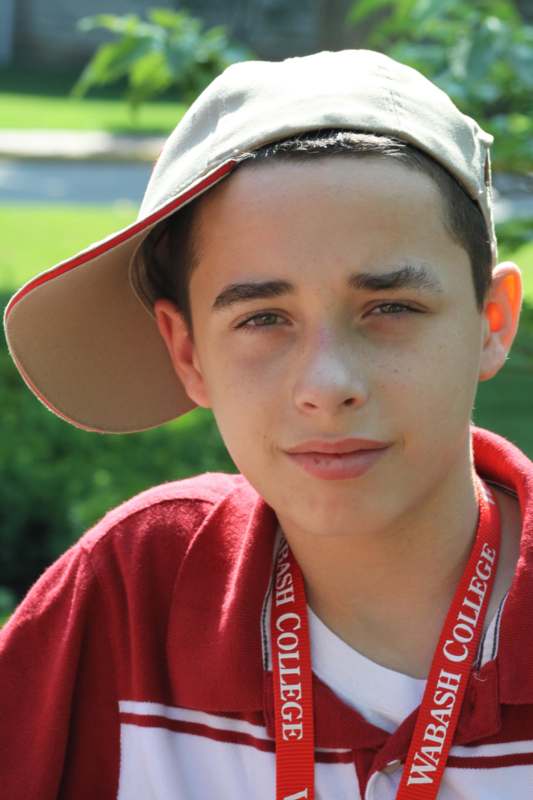 a boy wearing a hat and a red shirt