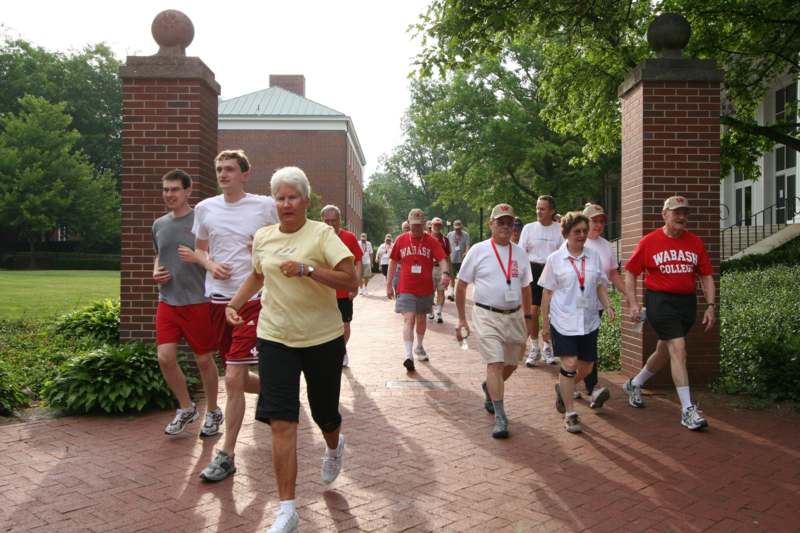 a group of people running on a brick path