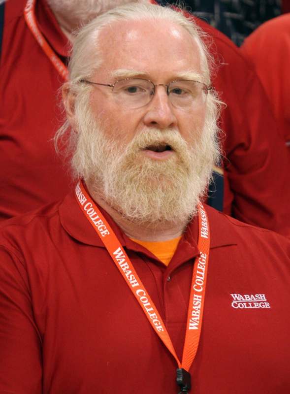 a man with a beard wearing a red shirt