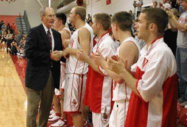 a coach shaking hands with a basketball team