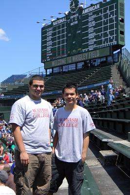 men standing in front of a scoreboard
