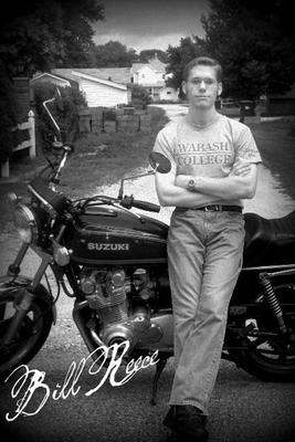 a man leaning on a motorcycle