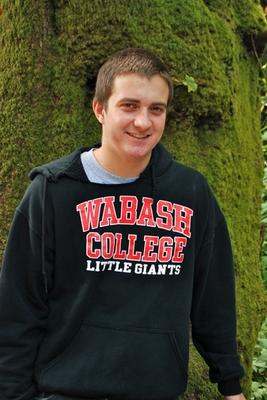 a man standing next to a tree