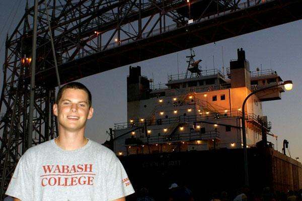 a man standing in front of a ship