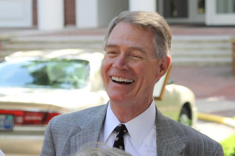 a man in a suit laughing