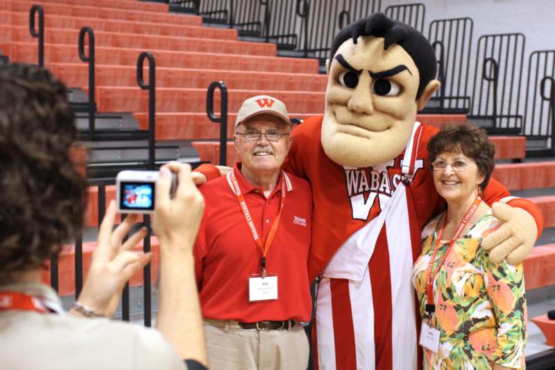 a man taking a picture with a mascot