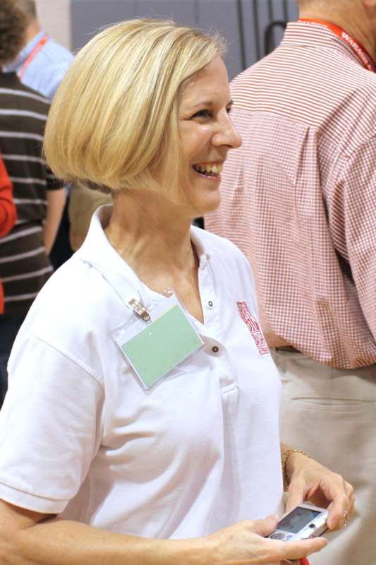 a woman smiling with a badge on her neck