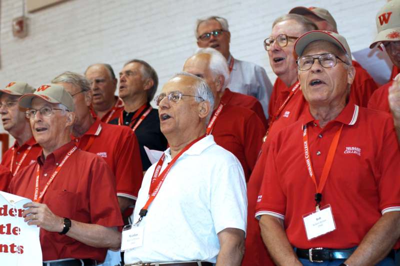a group of older men singing