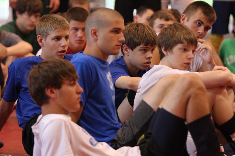 a group of boys sitting on the floor