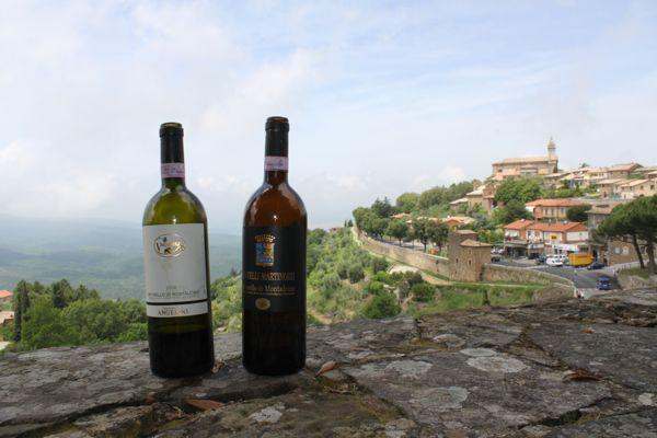 two bottles of wine on a stone wall