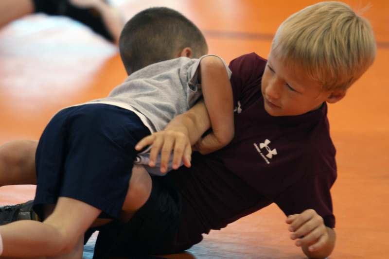 a boy wrestling another boy
