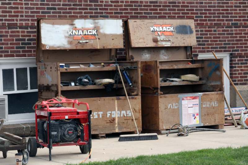 a group of boxes with tools in front of a brick building