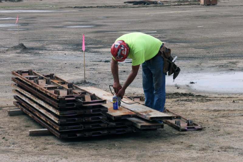 a man in a helmet working on a metal structure