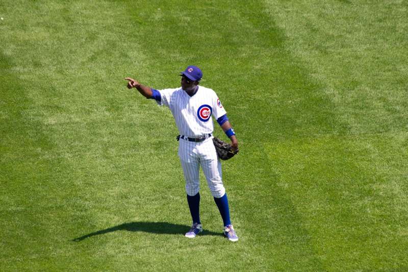 a baseball player in uniform pointing to the ground