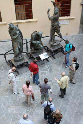 a group of people looking at statues
