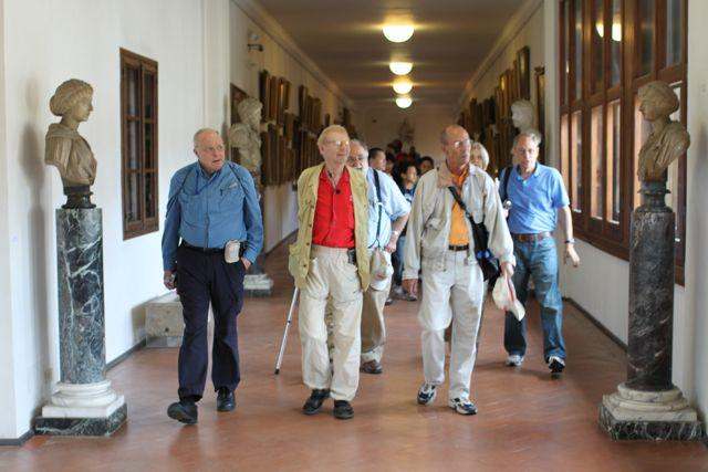 a group of men walking in a hallway