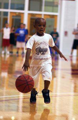 a young boy playing basketball