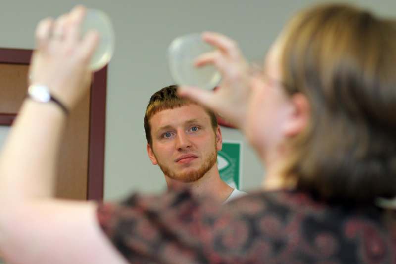 a man looking at a woman in the mirror