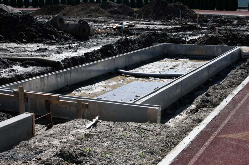 a construction site with a large rectangular pool