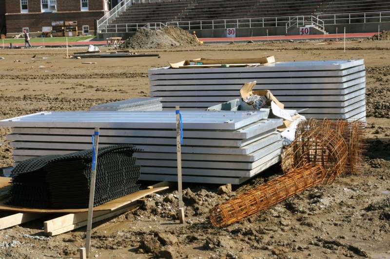 a pile of metal sheets on a dirt field