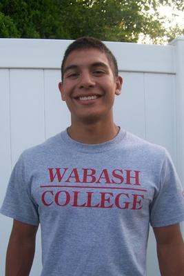 a young man smiling for a picture