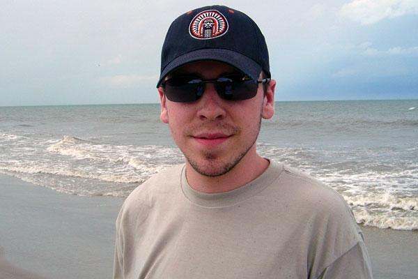 a man wearing a hat and sunglasses
