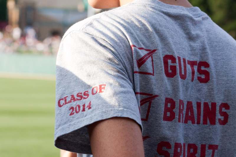 a person wearing a grey shirt with red text on it