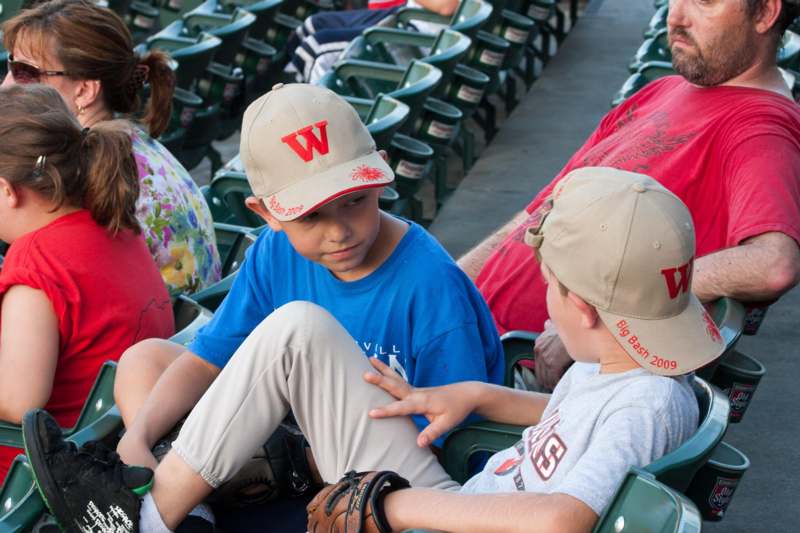 a group of kids sitting in a stadium