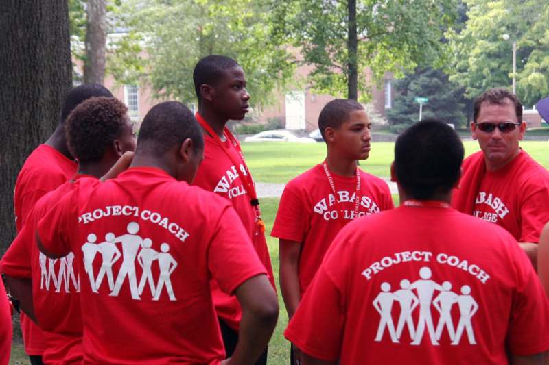 a group of young men wearing red shirts
