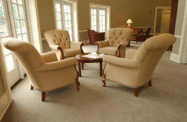 a room with beige chairs and a table