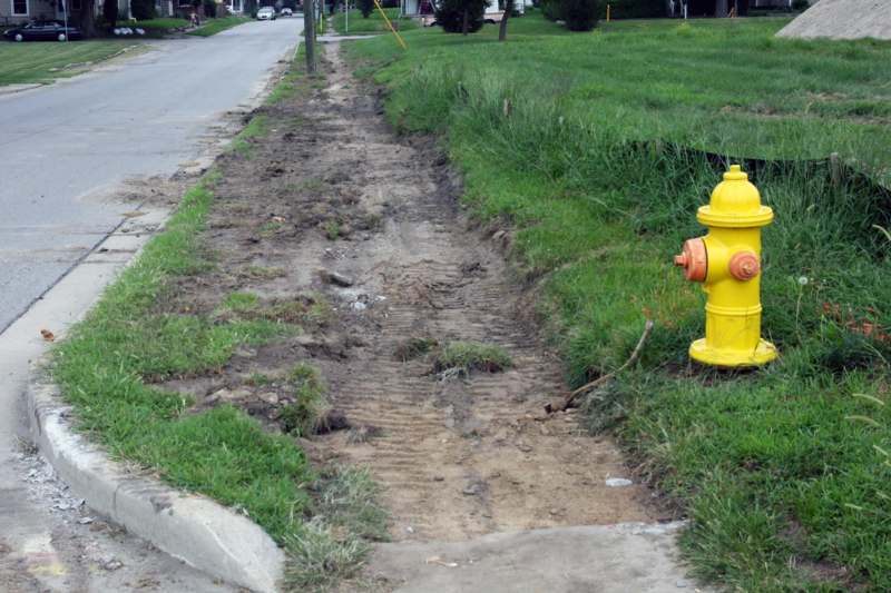 a yellow fire hydrant on the side of a road